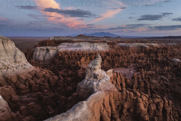 Stunning aerial photograph capturing Goblin Valley State Park, Utah, at sunset with its unique rock formations under a vibrant sky