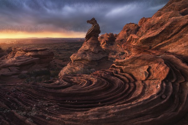 Striking rock formations captured at sunset in Coyote Buttes, Paria Canyon-Vermilion Cliffs Wilderness, showcasing the weathered sandstone against a vibrant sky in Arizona, USA