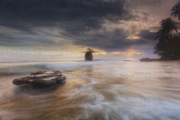 Before traveling to Costa Rica's extreme southeast to photograph the wild and isolated Gandoca/Manzanillo National Wildlife Refuge, I looked up lots of pics on Google to see what beaches might have the ingredients for a great coastal scenic. This beach, with the large exposed coral reef shelf (about the size of a large conference room table) and the scraggly tree-studded island off the coast, caught my eye. Now it was time for a little research. I assumed I wanted to shoot at sunrise since I was on the Caribbean (Atlantic) coast. Checking a great digital app called the Photographer's Ephemeris hit me with some knowledge. Because of the way Costa Rica is positioned geographically and the way this particular spot juts out from the mainland, I could actually shoot this beach with the sun in the frame at both sunrise and sunset. Amazing! But, sunset would cause a shadow on the tidal outcrop that I knew I wanted as my main foreground subject. Sunrise it was. Checking a tide chart, I found t...