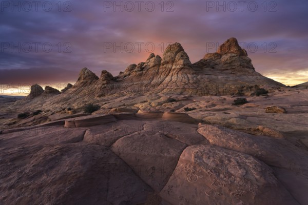 A majestic sunset casts warm colors over the unique sandstone formations at Coyote Buttes, located in the Paria Canyon-Vermilion Cliffs Wilderness, Arizona, USA