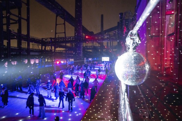 Ice rink at the Zollverein coking plant, ice skating with music and many lighting effects, Essen, North Rhine-Westphalia, Germany