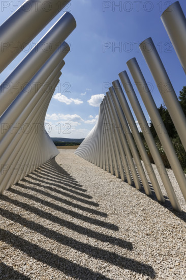 Art in public space, sculpture made of aluminum profile pipes by artist Martin Burchard, life's horizon path near Mundingen, light and shadow, gravel, clouds, blue sky, walk-in art, paths of reflection and refreshment on the Ehinger Alb, Baden-Württemberg, Germany