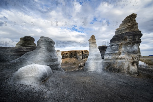 Eroded rock formations, volcanic landscape with dramatic cloudy skies, Ciudad Estratificada or Los Roferos, Antigua Rofera de Teseguite, Lanzarote, Canary Islands, Spain