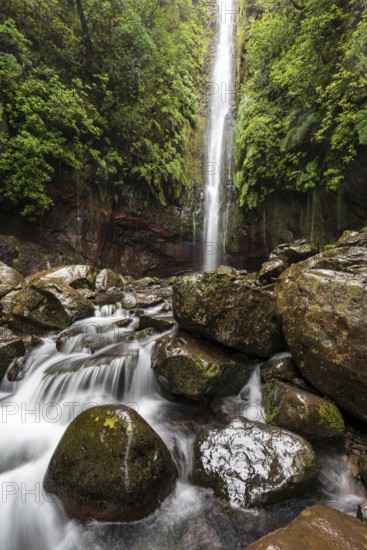 High waterfall on the Levada das 25 Fontes e Risco, surrounded by moss-covered rocks, Rabaçal nature reserve, Laurisilva laurel forest, Madeira, Portugal