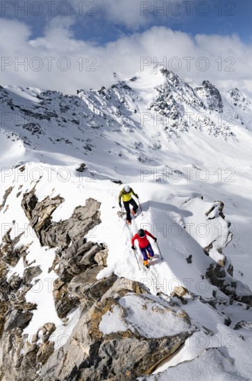Two mountaineers climbing the narrow ridge of Piz Laviner, view of mountain panorama in winter mountain landscape, Grisons Haute Route, Albula Alps, Rhaetian Alps, Grisons, Eastern Switzerland, Switzerland
