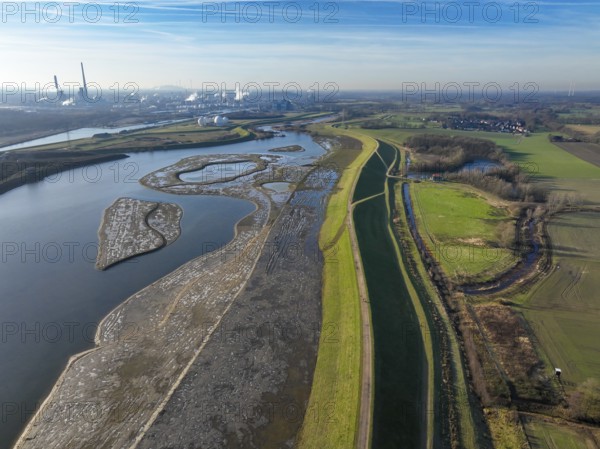 Haltern-Marl, North Rhine-Westphalia, Germany - Lippe, flood protection in the Haltern-Lippramsdorf-Marl area (HaLiMa) . Flood protection on the River Lippe by relocating the dyke and thus extending the floodplain. On the right, the completed floodplain north, the north dyke. Work is still underway on the south dyke. Marl Chemical Park in the back