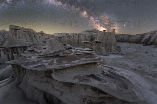 A captivating night view of unique rock formations under a vibrant Milky Way in Utah, USA, showcasing the natural beauty and tranquility of this desert landscape