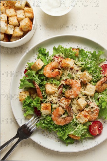 Caesar salad, with shrimp, on a white background, homemade, no people