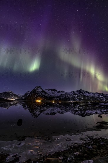 Northern lights over fjord, steep mountains, winter, aurora borealis, Flakstadoya, Lofoten, Norway