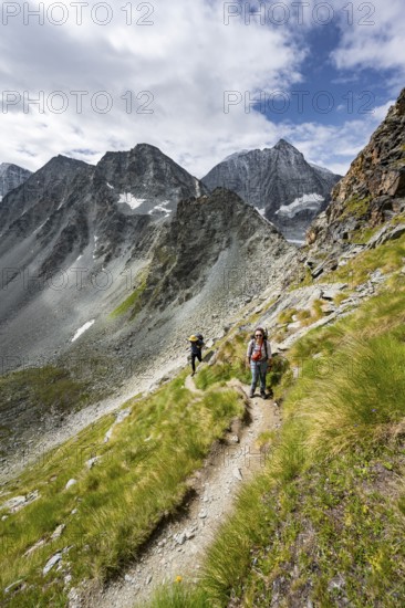 Mountaineer on a hiking trail, mountain landscape, ascent to Col de Riedmatten, behind summit Mont Blanc de Cheilon, Valais, Western Alps Switzerland