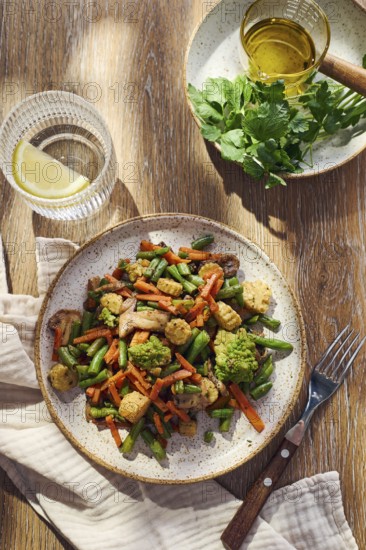 Plate of stir-fried mixed vegetables with green beans, carrots, baby corn, romanesco and mushrooms
