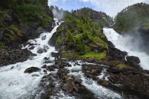 Summer day visiting Låtefossen falls near Odda, flowing water and green valley, Vestland, Norway