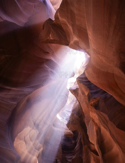 Antelope Canyon's breathtaking light beams illuminate the textured sandstone walls, creating a magical and serene atmosphere. A true marvel of natural beauty in the USA