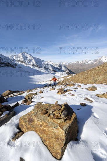 Mountaineer on a hiking trail with snow, descent from Ramoljoch at Spiegelferner, autumnal mountain landscape, mountain panorama, Ötztal Alps, Tyrol, Austria