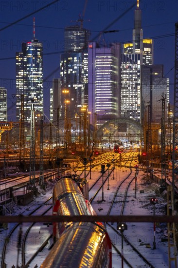 Railway tracks in front of the main railway station in Frankfurt am Main, skyline of skyscrapers in the Cit, winter, snow, dusk, Hesse, North Rhine-Westphalia