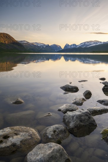 Mountains of the Kebnekaise massif reflected in Lake Ladtjojaure, Nikkaluokta, Lapland, Sweden