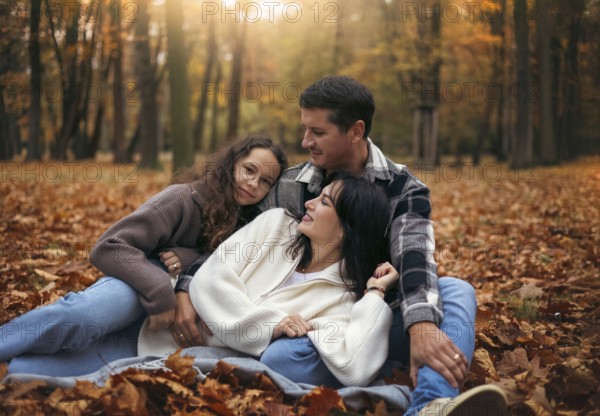 A joyful family relaxes in a forest amidst colorful autumn leaves. The warm tones and soft light create a cozy and heartwarming atmosphere, ideal for seasonal themes