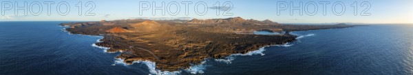 Coast with lava fields, volcanic landscape near Los Hervideros with red volcano Montaña Bermeja, in the evening light, aerial view, Lanzarote, Canary Islands, Spain