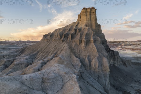 A breathtaking landscape of towering rock formations captured at sunset, showcasing the serene beauty of Utah's rugged terrain under a softly lit sky