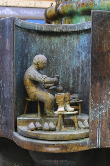 Guild fountain by the sculptor Bonifatius Stirnberg from 1983, guilds, guilds, craftsmen, cast figure, shoemaker, shoe processing, Reutlingen, Baden-Württemberg, Germany