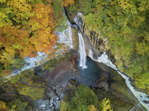 Aerial view of Berglistüber waterfall in autumn-colored surroundings, Linthal, Klausenpass, Canton of Glarus, Switzerland