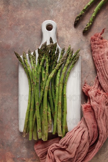 Bouquet of fresh asparagus, on an abstract background, top view, rustic, no people