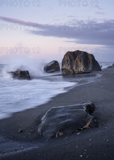 Okarito Beach, rocks, ocean, sandy beach. In the evening. long exposure. Westland Tai Poutini National Park, West Coast, South Island, New Zealand