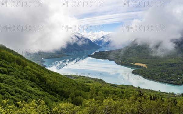View of snowy mountains in spring and turquoise blue Kenai Lake, Slaughter Ridge Trail, Cooper Landing, Kenai Peninsula, Alaska, USA