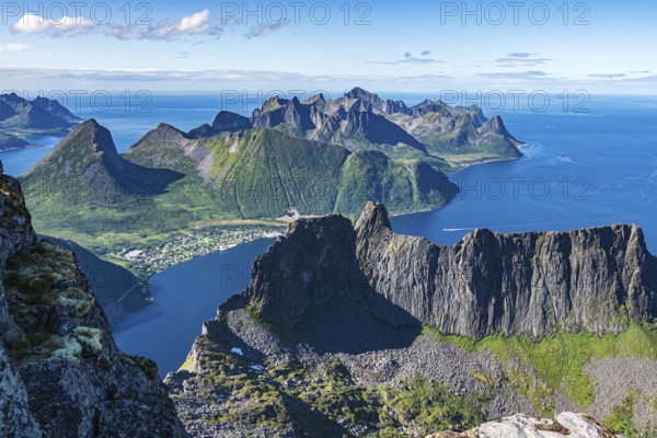 Aerial view from top of Mt. Grytetippen towards village Fjordgard, Mt. Segla and Mt. Hesten, Senja Island, Norway