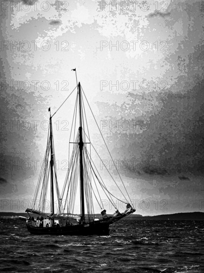 A sailing ship in black and white on the sea with dramatic sky, Baltic Sea, Germany