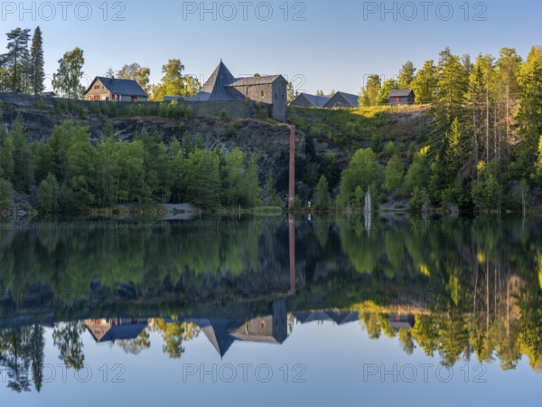 The slate lake in the Kießlichbruch in the evening light, former slate quarry, Technical Monument Historic Slate Mining Lehesten, Thuringia, Germany