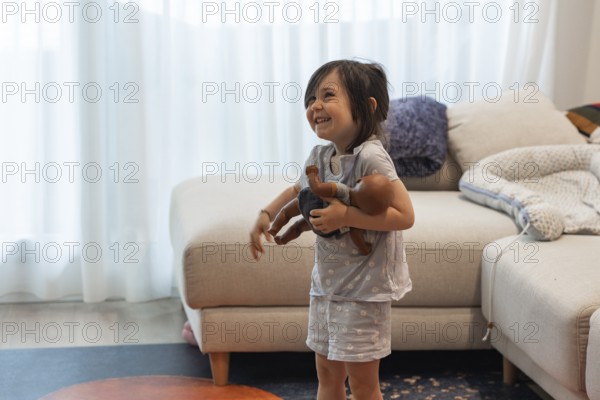 A young girl joyfully embraces her doll in a cozy living room, symbolizing love and innocence. The child's playful expression adds warmth to the vibrant home setting