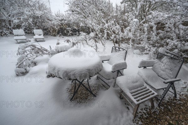 Snowy seating in a garden, Eckental, Middle Franconia, Bavaria, Germany