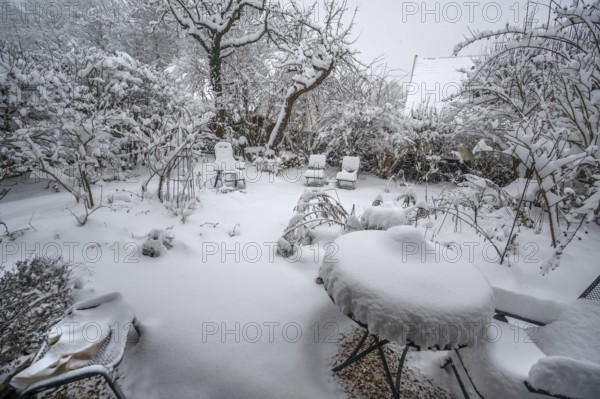 Snow-covered seats in a garden, Eckental, Middle Franconia, Bavaria, Germany