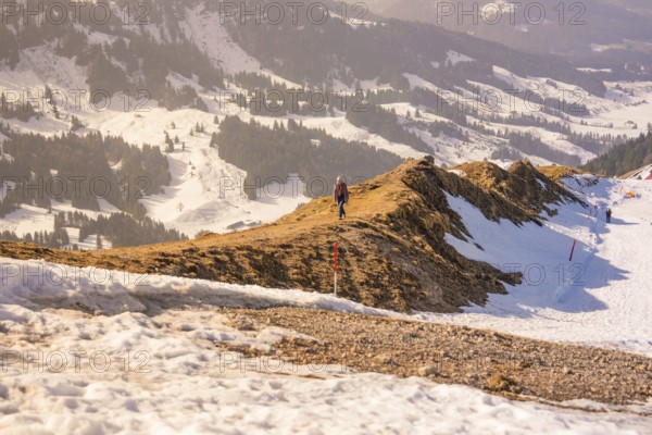 Landscape with snow-covered mountains and a narrow hiking trail that snakes through the winter landscape, Hochgrat Mountains, Allgäu Alps, Oberreute, Germany