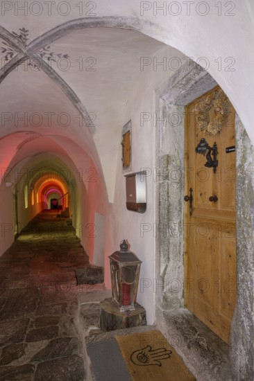 Colourfully illuminated cloister in the Carthusian monastery of Allerengelberg, Schnalstal Valley, Karthaus, South Tyrol, Italy