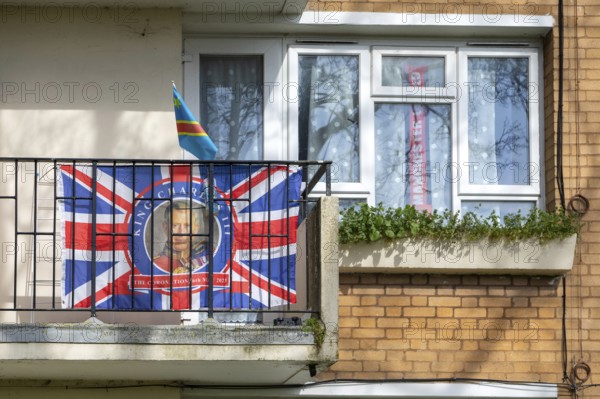 Patriotic Union Jack flag featuring King Charles on balcony of flat, Sydenham, Lewisham, London, SE26, England, UK