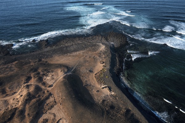 Aerial view of Popcorn Beach, striking coastline with natural volcanic landscapes contrasting against the serene turquoise waters in Fuerteventura
