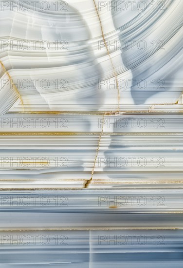 A macro photograph showcasing the striking linear patterns and mineral details inside a Whitcomb Creek geode from Oregon, highlighting its intricate crystal formations and smooth textures