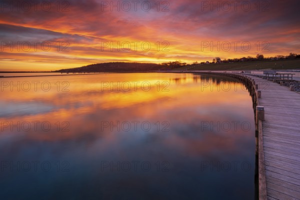 Jetty at sunrise on Geiseltalsee, artificial lake, open-cast mining lake, recultivated open-cast mine, post-mining landscape, Marina Braunsbedra, Saxony-Anhalt, Germany