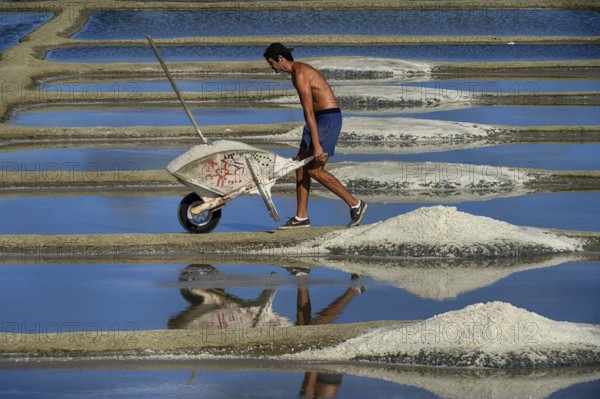 France, Brittany, A man extracting salt in Salants de Guerande