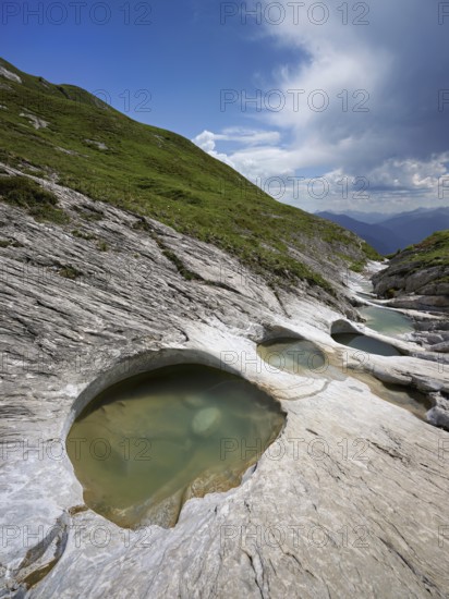Glacier mill with glacier pots on the Trinser Alp Mora, Trin, Canton Graubünden, Switzerland