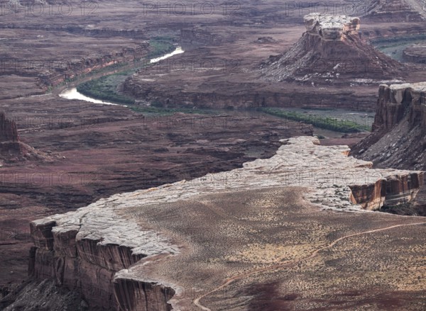 Aerial view of Canyonland national park striking landscape showcasing a winding river through rugged, layered rock formations, highlighting the natural beauty of this iconic location