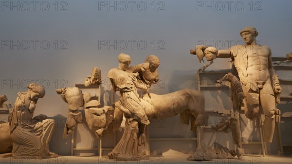 On the right, the god Apollo, west pediment of the Temple of Zeus, battle between lapiths and centaurs, ancient marble sculptures in a museum exhibition, showing fragmented figures from classical antiquity, Olympia Archaeological Museum, Ancient Olympia, Olympia, Peloponnese, Greece