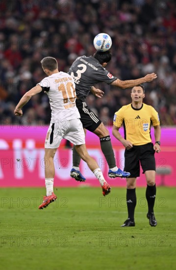 Florian Wirtz Bayer 04 Leverkusen (10) v Min-jae Kim FC Bayern Munich FCB (03) Referee Referee Felix Zwayer observes, Allianz Arena, Munich, Bavaria, Germany