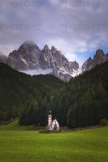 View of the church of St. Johann in Ranui with the Geißler group in the background, Dolomites, Puez-Geisler nature park Park, St. Magdalena, Villnöß, Funes, Villnößtal, South Tyrol, Italy