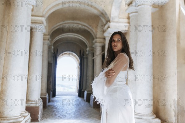 Elegant bride poses in an ancient villa in Treia, Macerata, capturing the timeless beauty of an Italian wedding setting with classical architecture and serene ambiance