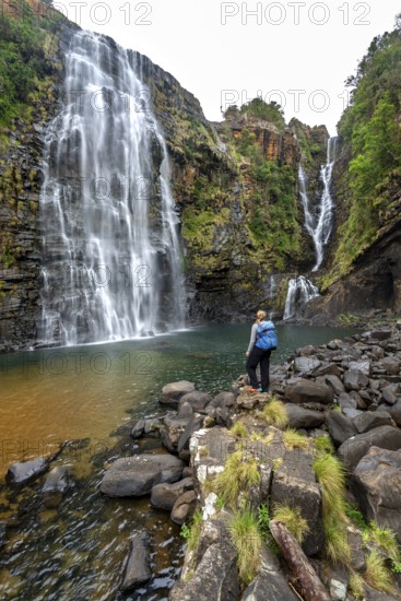 Young woman standing in front of a waterfall, Lisbon Falls, long exposure, near Graskop, Mpumalanga, South Africa