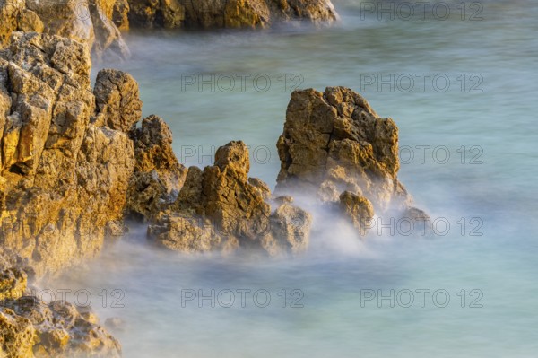 Crystal clear and turquoise water on the beach of Ustrine Bay on a sunny day at sunset on the island of Cres, long exposure, Croatia