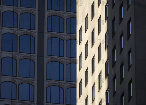 Architectural styles of two adjacent modern buildings in New York, capturing their unique facades under sunlight